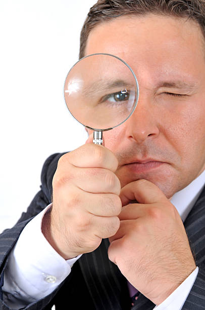 istock businessman's eye in the magnifying glass 173575064