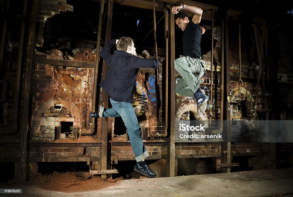 Two fighters Fighting series - two men in combat in a grungy area. Graffiti Stock Photo