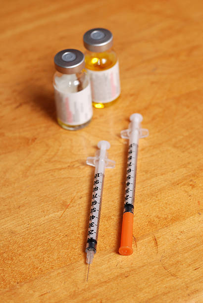 istock Two syringes and medicine vials 173575478