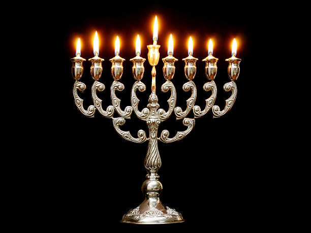 istock Menorah with nine lit candles on a black background 173575818