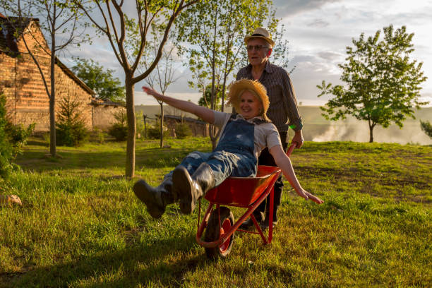istock Happy senior couple playing with a wheelbarrow 1735767666