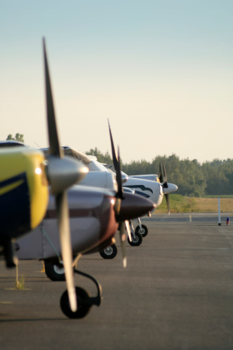 Line of small planes in a small airport in Drummondville during sunset.