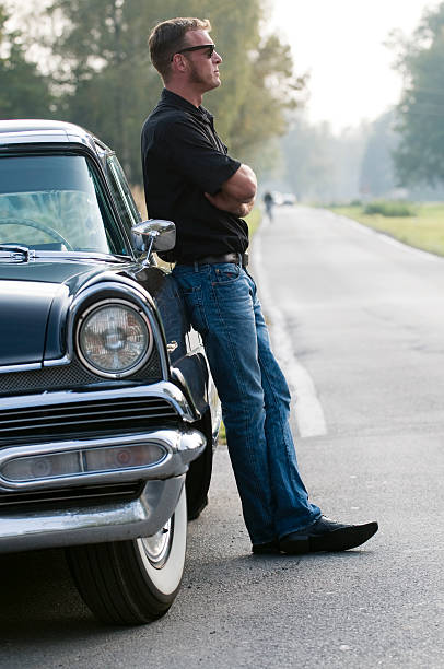 istock A young man leaning on a vintage car 173577891