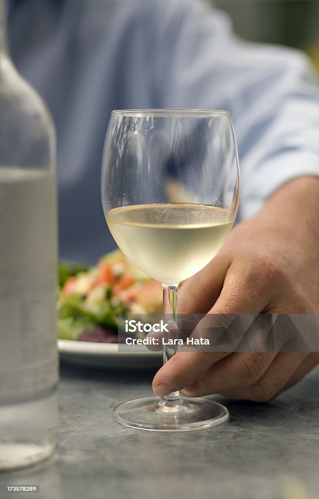 Wine Glass A glass of wine being held at the base Chablis Wine Stock Photo