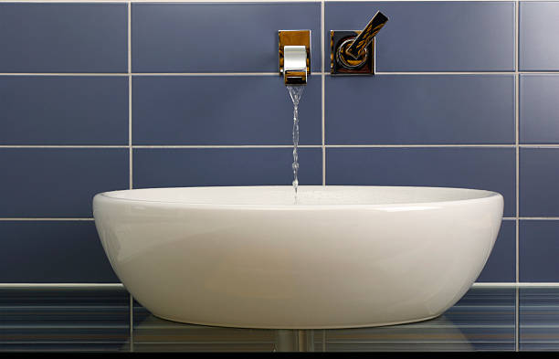 Modern bathroom sink Sink in the bathroom standing on a glass shelf with modern pipe on the wall.Similar images: bathroom sink stock pictures, royalty-free photos & images