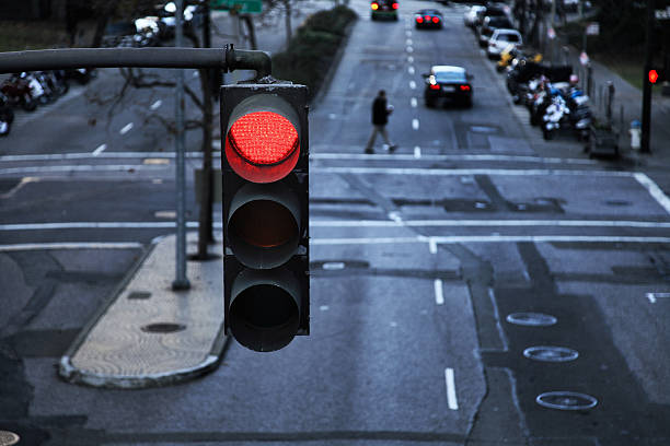 Red light hanging above a paved street in the city stock photo