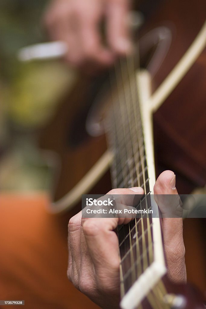Guitar player Gutar player. Selective focus with very small DOF! Focus on fingers  Adult Stock Photo