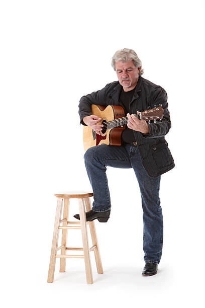 Photo of a male guitar player one of my Guitar Hero series. Shot on Canon EOS 1Ds mark 3 and 24-70mm L lens. This image is shot on a white background with some drop shadow left under the player. (NOT CLIPPED OUT).