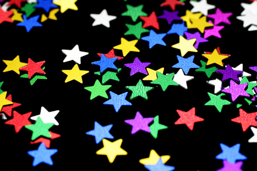 Macro shot of star shape beads pattern against black background.