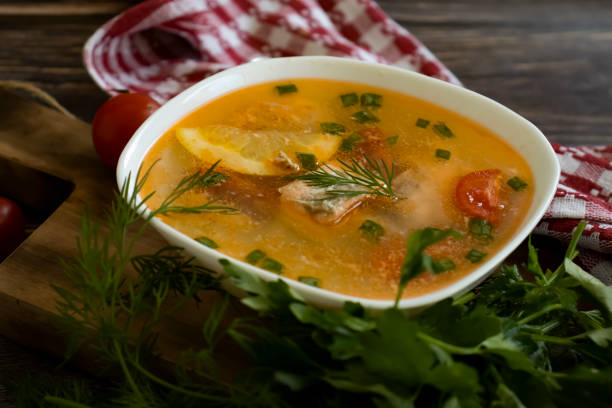 istock Soup with salmon, lemon on old background 1735807380