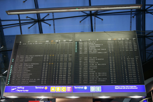 A table with flight destinations at the airport.