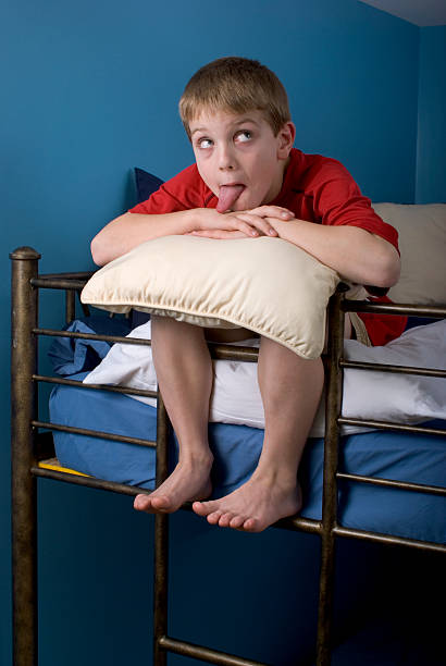 istock Silly Boy On Bunk Bed Feet Hanging Over 173581216