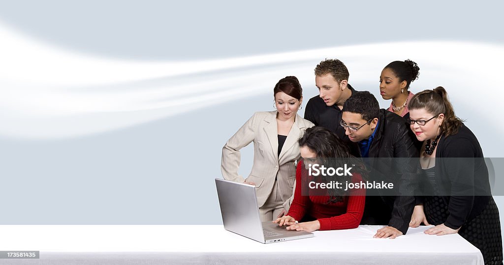 Working on the Laptop Six business people work on laptop. 20-29 Years Stock Photo