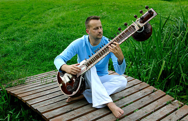 man with oriental sitar man with oriental sitar jin jang stock pictures, royalty-free photos & images
