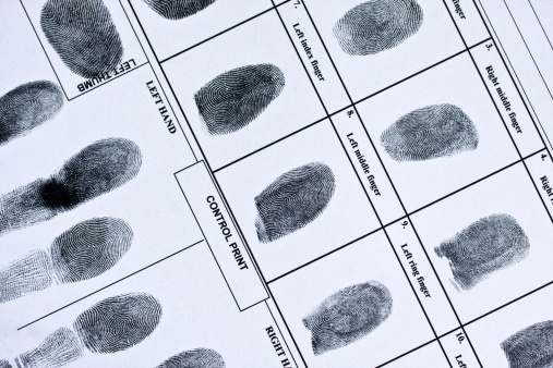 Red fingerprint on a white paper, as background. Bloody red finger print. Index fingerprint.