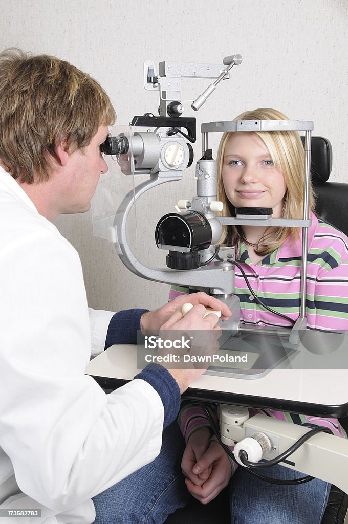 Eye Exam (XL) Teenager getting her eyes measured with a Slit Lamp Microscope.PLEASE CLICK ON THE IMAGE BELOW TO SEE MY MEDICAL TECHNOLOGY LIGHTBOX: Adolescence Stock Photo