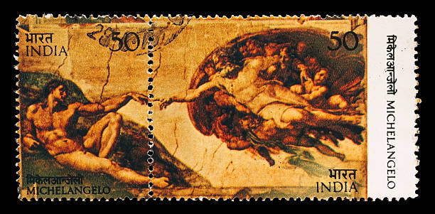 Michelangelo's Creation of Adam postage stamps "1975 India postage stamps containing the Creation of Adam, a fresco on the ceiling of the Sistine Chapel by Michelangelo Buonarroti (1475-1564), Italian sculptor, painter, and architect. Both stamps from the se-tenant block are cancelled in the upper portion where they meet. DSLR with 100mm macro; no sharpening." adam and eve painting stock pictures, royalty-free photos & images
