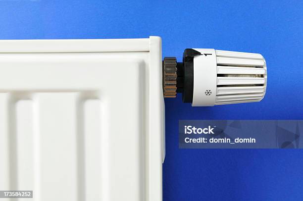 Closeup Of White Thermostat And Radiator On Blue Background Stock Photo - Download Image Now
