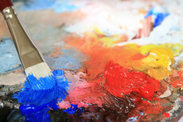 istock Paintbrush with oil paint on a classical palette 173584372