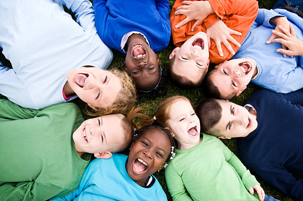 Group of Excited Children Lying in a Circle