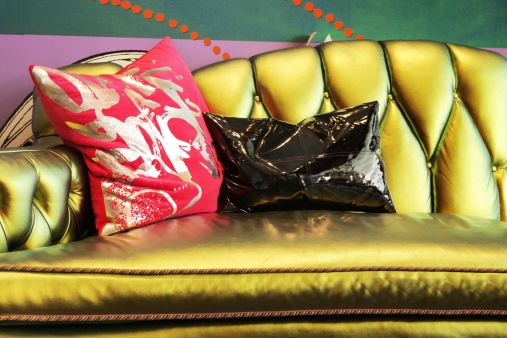 Stylish sofa pillow funky modern luxury home gold red black interior decor.