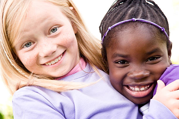 istock Two Happy Girls Smiling and Hugging Outside 173584702