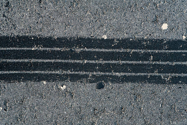 istock Tire track on weathered asphalt 173584758