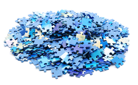 Above angle view of a large group of puzzle pieces on a table