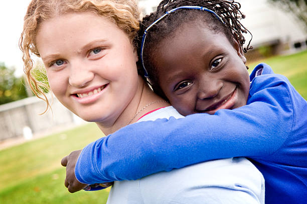 istock Two Girls Smiling and Hugging Outside 173585989