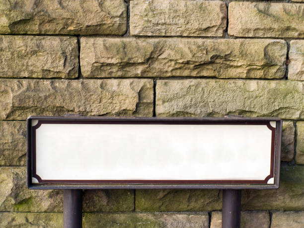 istock Blank street name sign against stone wall. 173586195