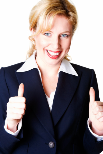 Young business woman showing thumbs up sign against white background