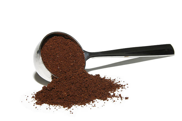 Ground coffee in a metal coffee scoop stock photo