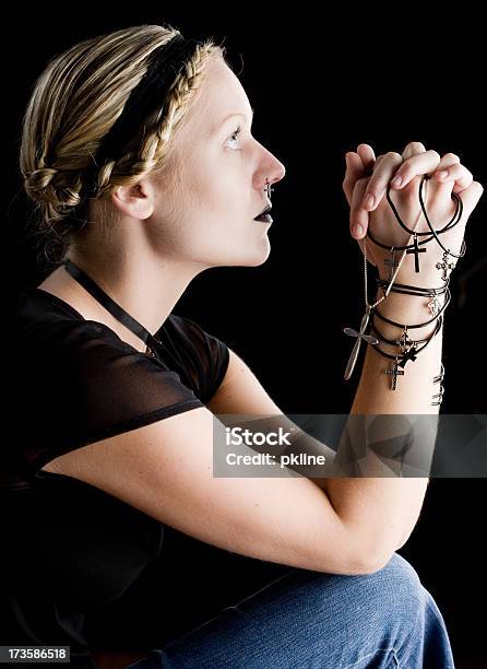 Young Woman Clasping Crucifixes And Looking Up Stock Photo - Download Image Now - 20-24 Years, Adult, Adults Only