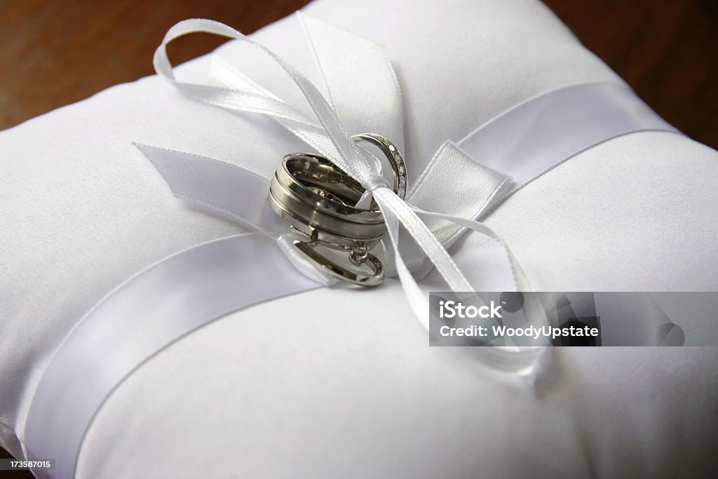 Wedding Rings on Pillow Wedding rings on a white pillow. Angle Stock Photo