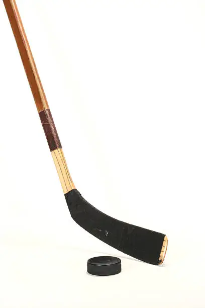 Photo of Hockey stick and pick on white background