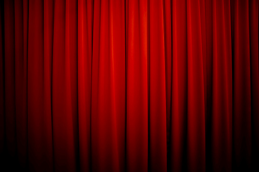 Royalty free stock photo of a theatre curtain background with vignette.