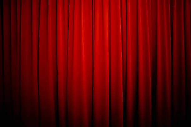 Royalty free stock photo of a theatre curtain background with vignette.