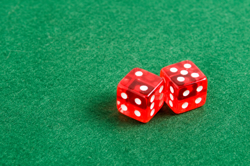 red dice on green background