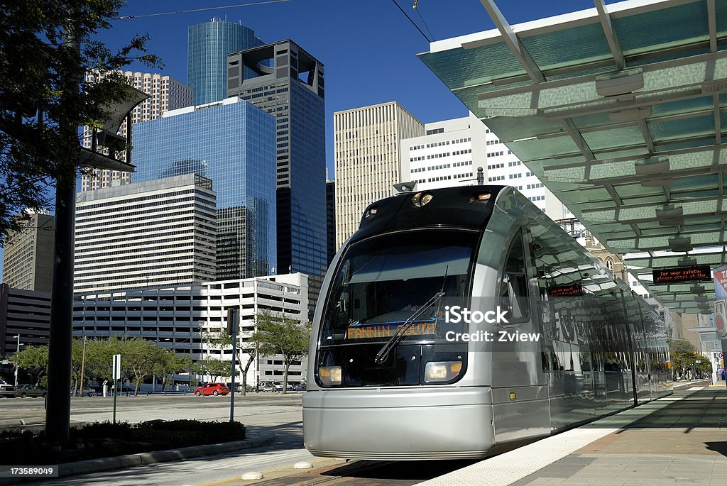 Metro Train at Platform With Modern Skyscrapers In Background This horizontal image shows a Metro Train stopped at a platform to pick up passengers.  It has modern sky scrapers in the background with a clear blue sky backdrop.Here are some similar images you might be interested in: Houston - Texas Stock Photo