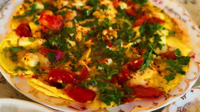 Cooking frittata with chicken eggs and fresh vegetables on pan in home kitchen.Delicious Italian breakfast meal preparation in close up. stock video