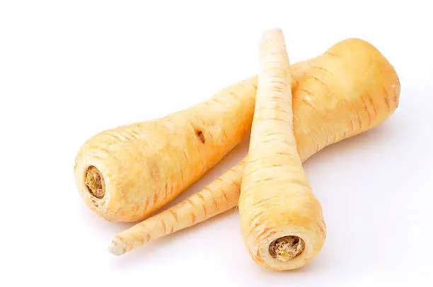 Three parsnips isolated on white.