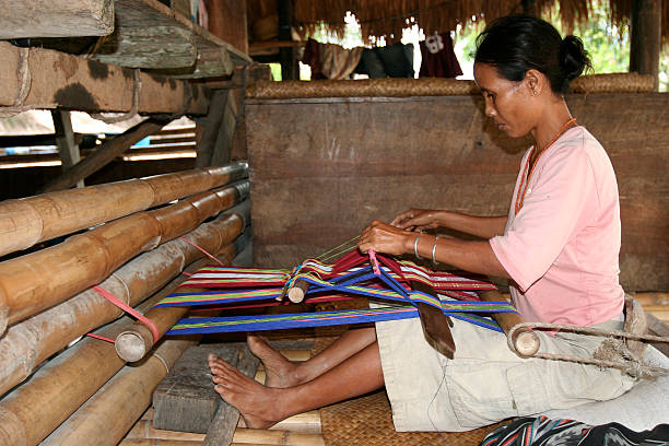 Elderly Burmese woman in a wooden building in the village of Bagan, on the Irrawaddy River, Myanmar