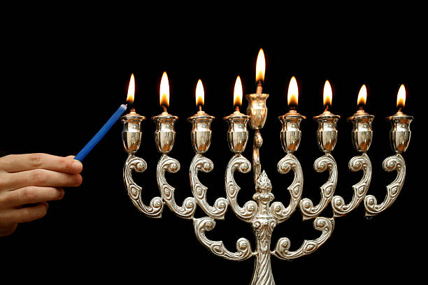 照明、メノラー - menorah hanukkah candle human hand ストックフォトと画像