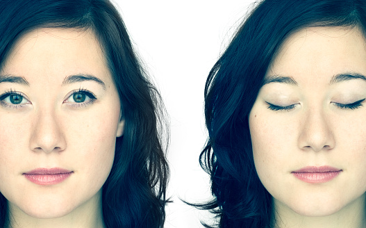 Symbolic double portrait of a young woman, eyes open, eyes closed. On white background and in crossprocced colours.