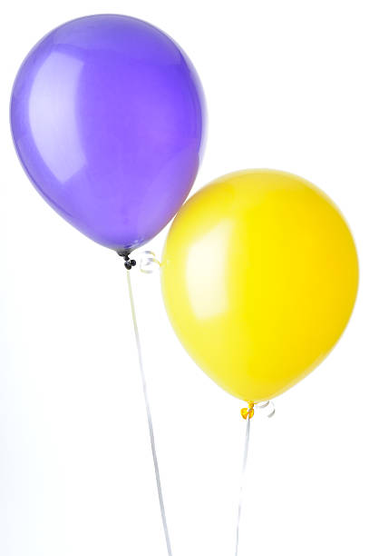 Purple and yellow helium balloons on ribbons, isolated against a white background.