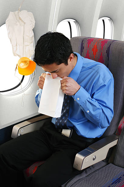 Depressurization Passenger getting air sick on a commercial airliner. oxygen mask plane stock pictures, royalty-free photos & images