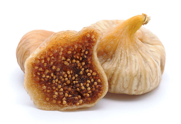 fichi secchi isolati su bianco - dried fig brown color image dried food foto e immagini stock