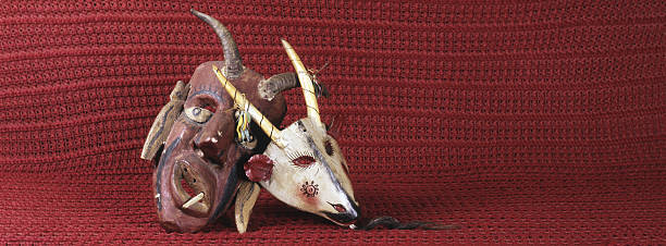 Devil and Goat Masks Devil Mask and Goat Mask from Mexico. These masks are carved around 1950s and used at ceremonies and animal dances. The photo is taken with a medium format camera, 50 mm wide angle lens. satan goat stock pictures, royalty-free photos & images