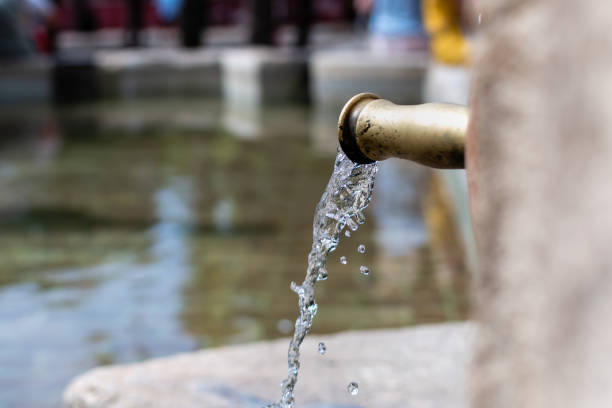 istock Transparent clean water flows in stream from copper tap 1735928616