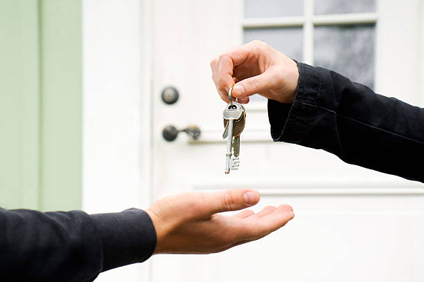 Key exchange Person exchanging keys with another. passing giving stock pictures, royalty-free photos & images